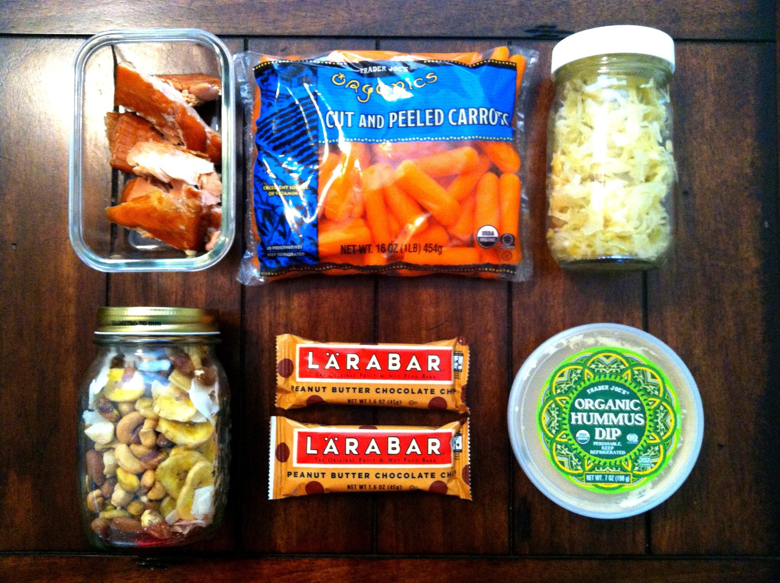 This trips's goodies include {from top left} smoked salmon, organic carrots, sauerkraut, mixed nuts with banana chips and unsweetened coconut, Larabars {this is our "sweet treat"} and organic hummus from TJ's {this is also a treat for the hubs as we don't usually do many beans}. We also have grass-fed beef jerky, apples and hard boiled eggs. Let's just put it this way- if we had to sit in traffic the entire weekend, we'd be well fed. 