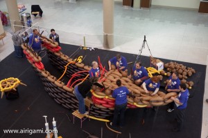 It takes a large crew to assemble this ship that will be one of the featured elements of the installation.