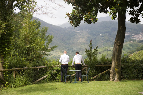 Groom looking out over great Tuscan landscape - photo by Pearl Pictures