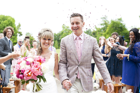 Confetti over bride and groom 