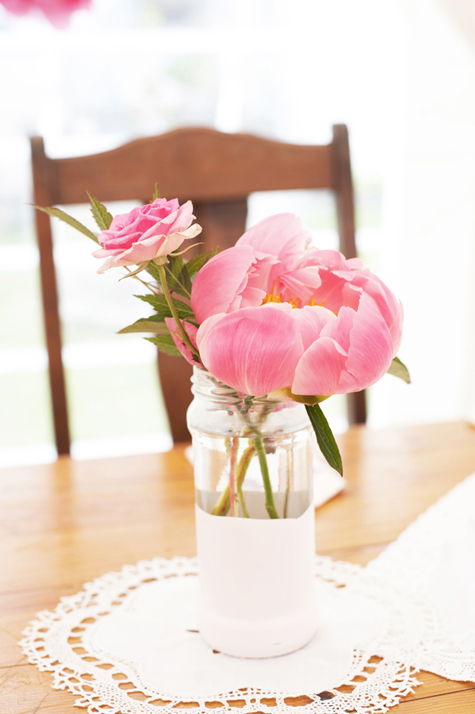 Pink peony in jar on table