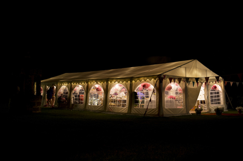 Exterior shot at night of marquee decorated with bunting