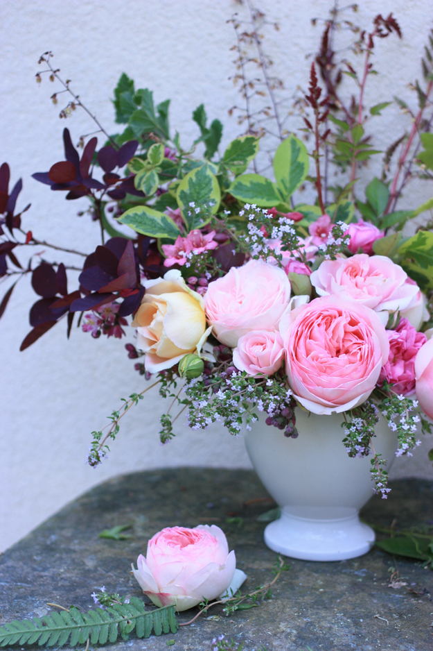 pink garden roses in a white vase