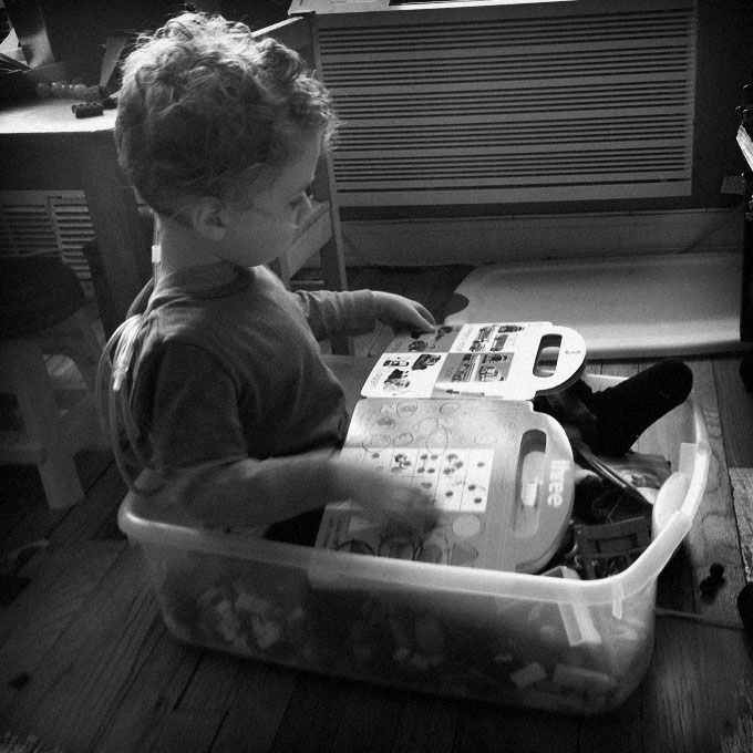 Reading in a toy box.