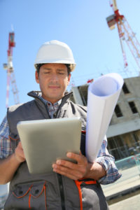Entrepreneur on building site using tablet