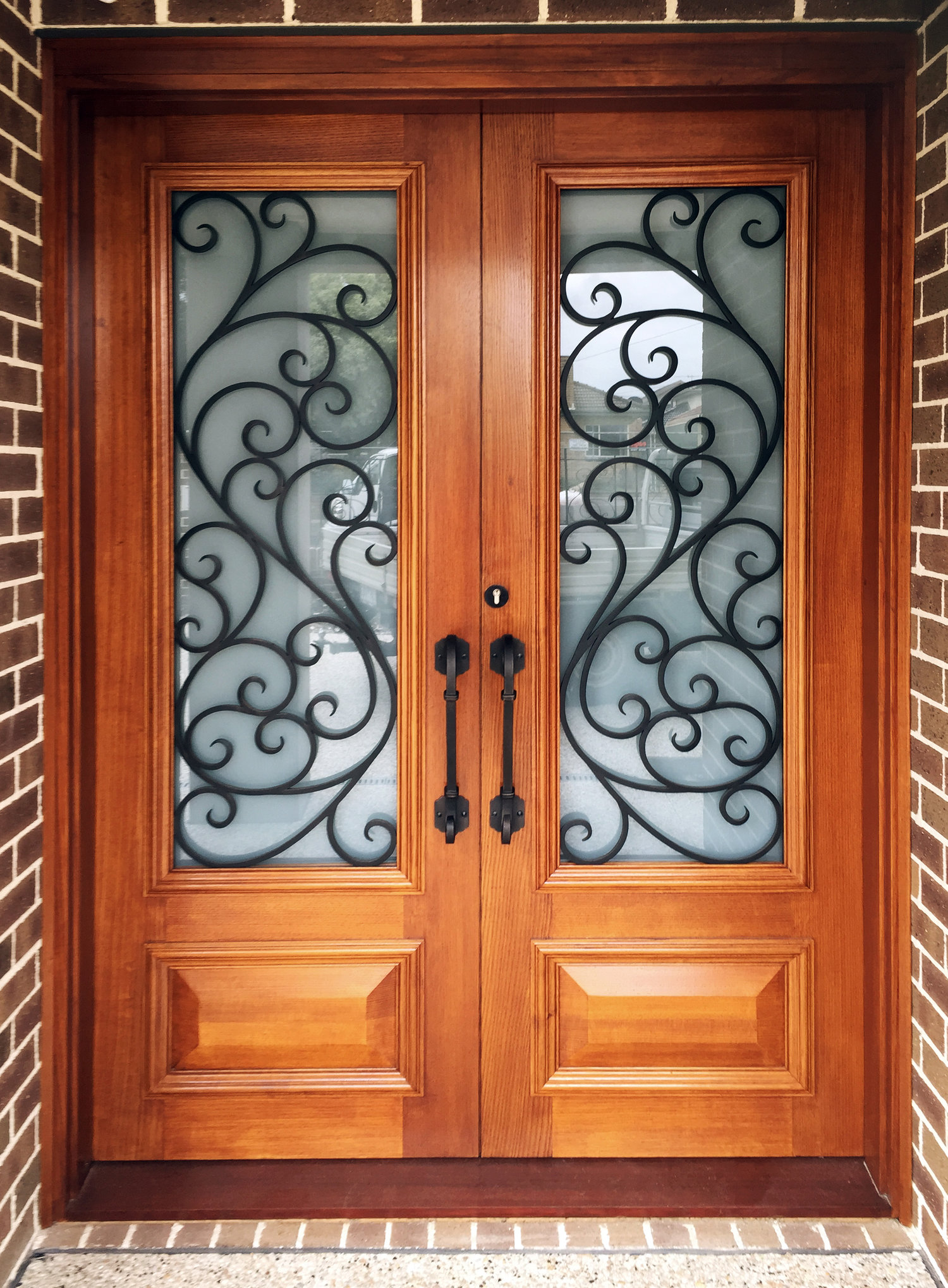 Wood doors with wrought iron