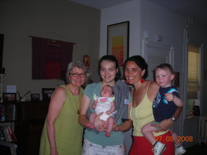 Rachel with her midwives and her two homeborn children!