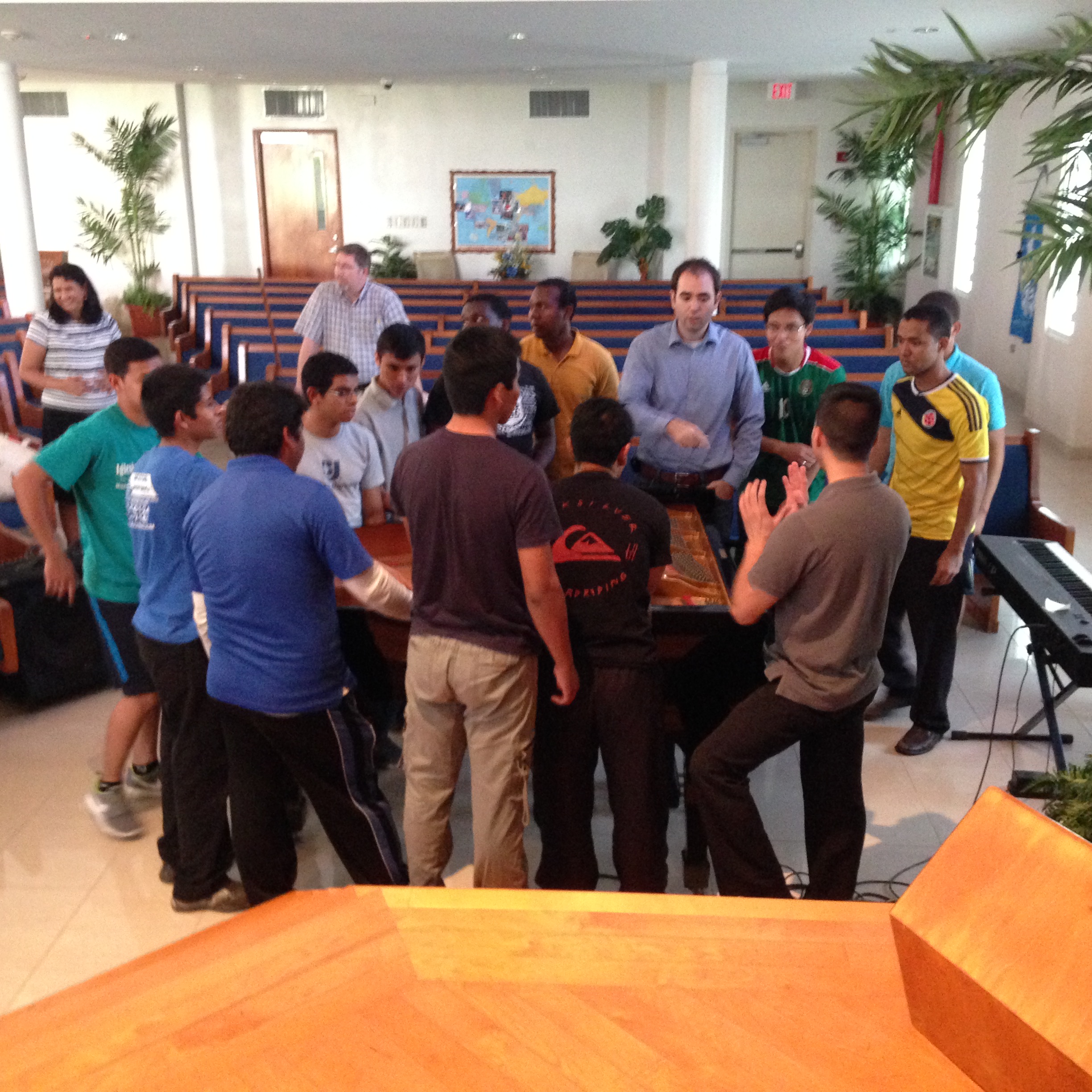 Moving the piano to the platform for the concert.  These guys are all students at Puerto Rico Baptist College.