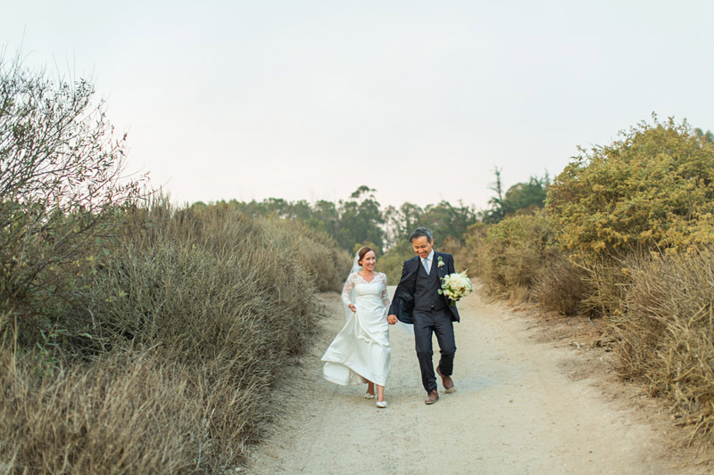 The Stow House Wedding Bride and Groom walking to the beach 