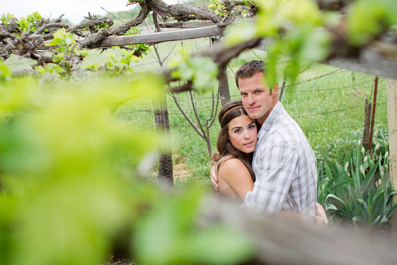 Santa Margarita Ranch, engagement photos of couple hugging under vines