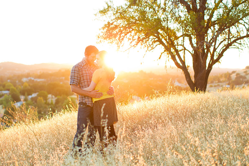 Santa Margarita family pictures of couple holding each other in the sunset on a golden hill. (2 of 3)