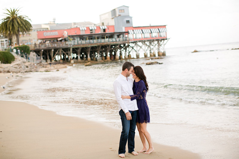 Monterey Engagement Photos of couple barefoot on beach. 