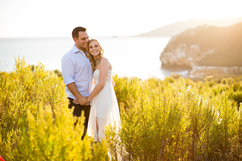 Avila Beach Engagement pictures of couple in glowing field on cliffs above the bay. (1 of 2)