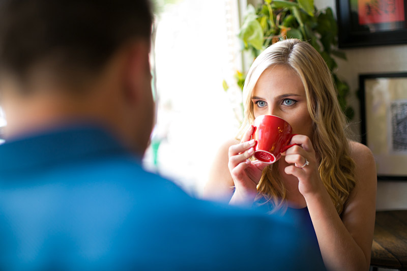 San Luis Obispo Engagement pictures of couple drinking coffee at cafe out of a red cup. (1 of 2)
