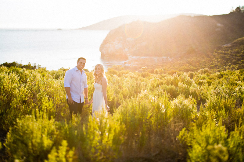 Avila Beach Engagement pictures of couple in glowing field on cliffs above the bay. (2 of 2)