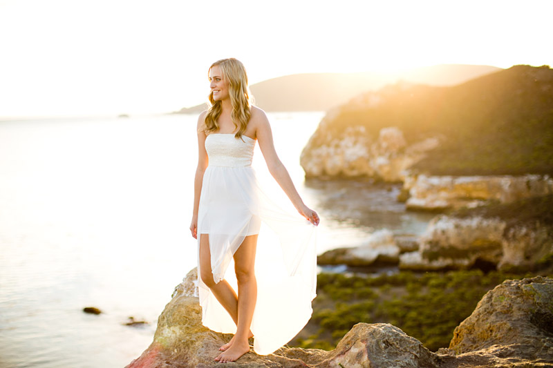 Avila Beach Engagement pictures of bride in flowing white dress on the cliffs overlooking Avila Bay. 
