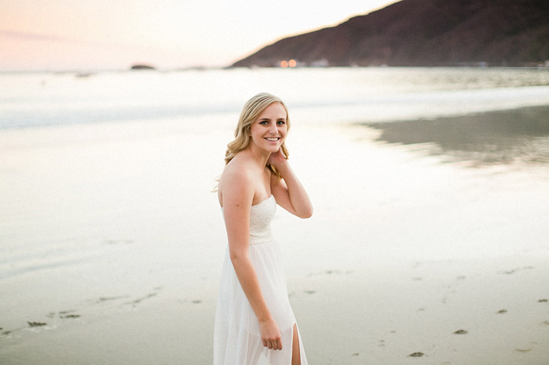 Avila Beach Engagement picture of girl in white dress looking over her shoulder. 
