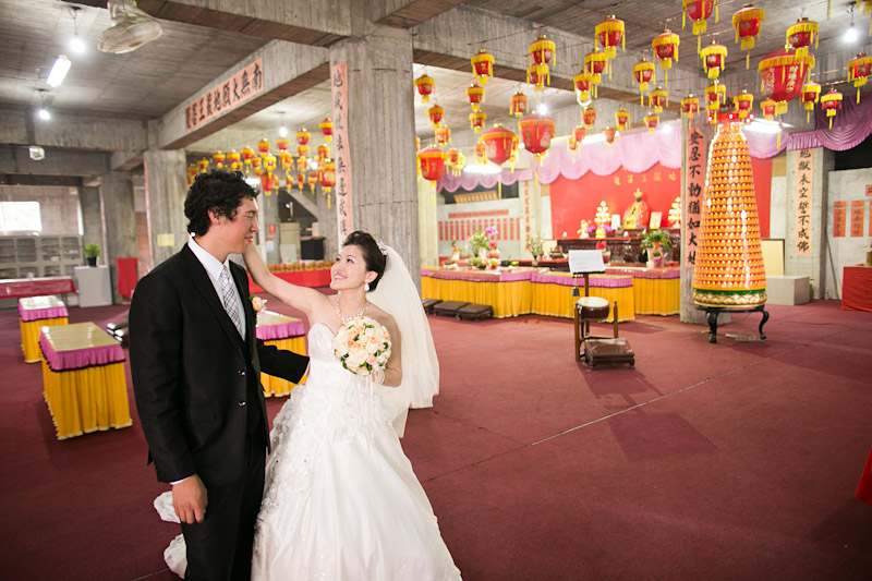 Taiwan wedding. Bride and groom in temple before ceremony.