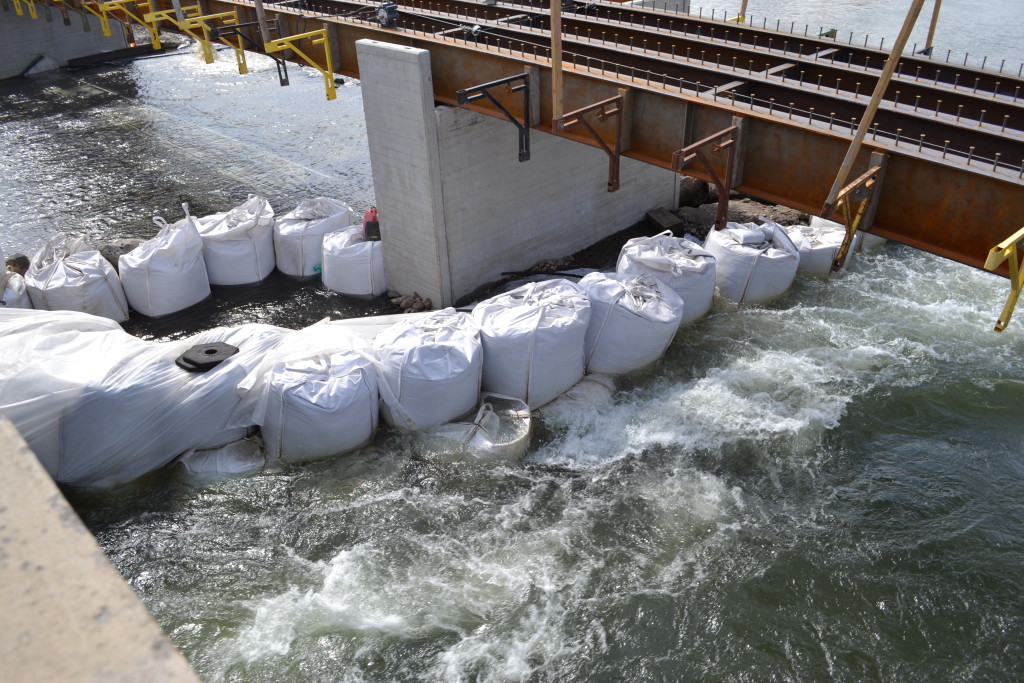 Large sandbags are used to form a cofferdam to divert water during construction. 