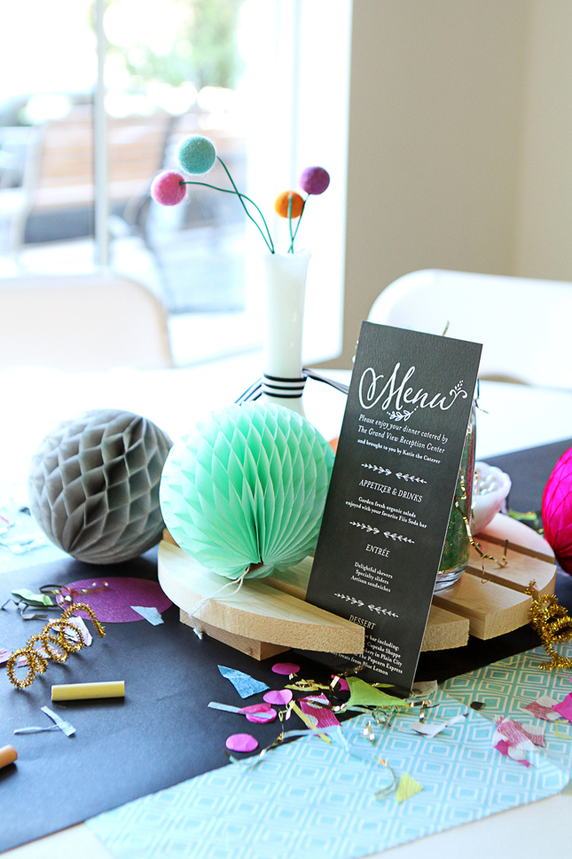 Such a fun confetti party table with felt balls in milk vases and honeycomb tissue balls.