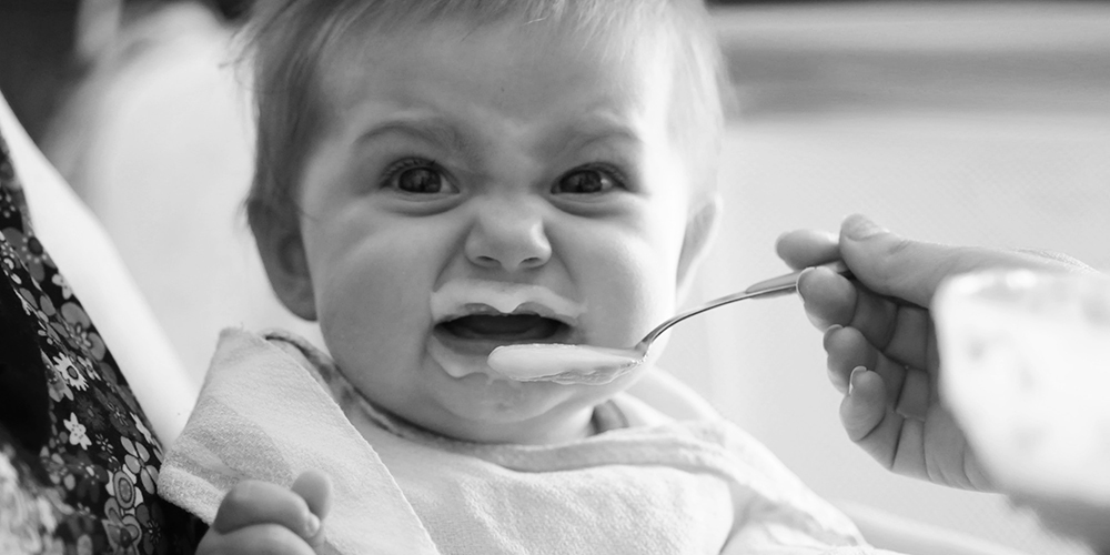 Little child cry with spoon.