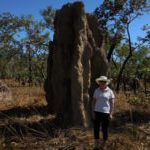 Me standing in front of an enormous magnetic north termite mound in Litchfield National Park in the Northern Territory.