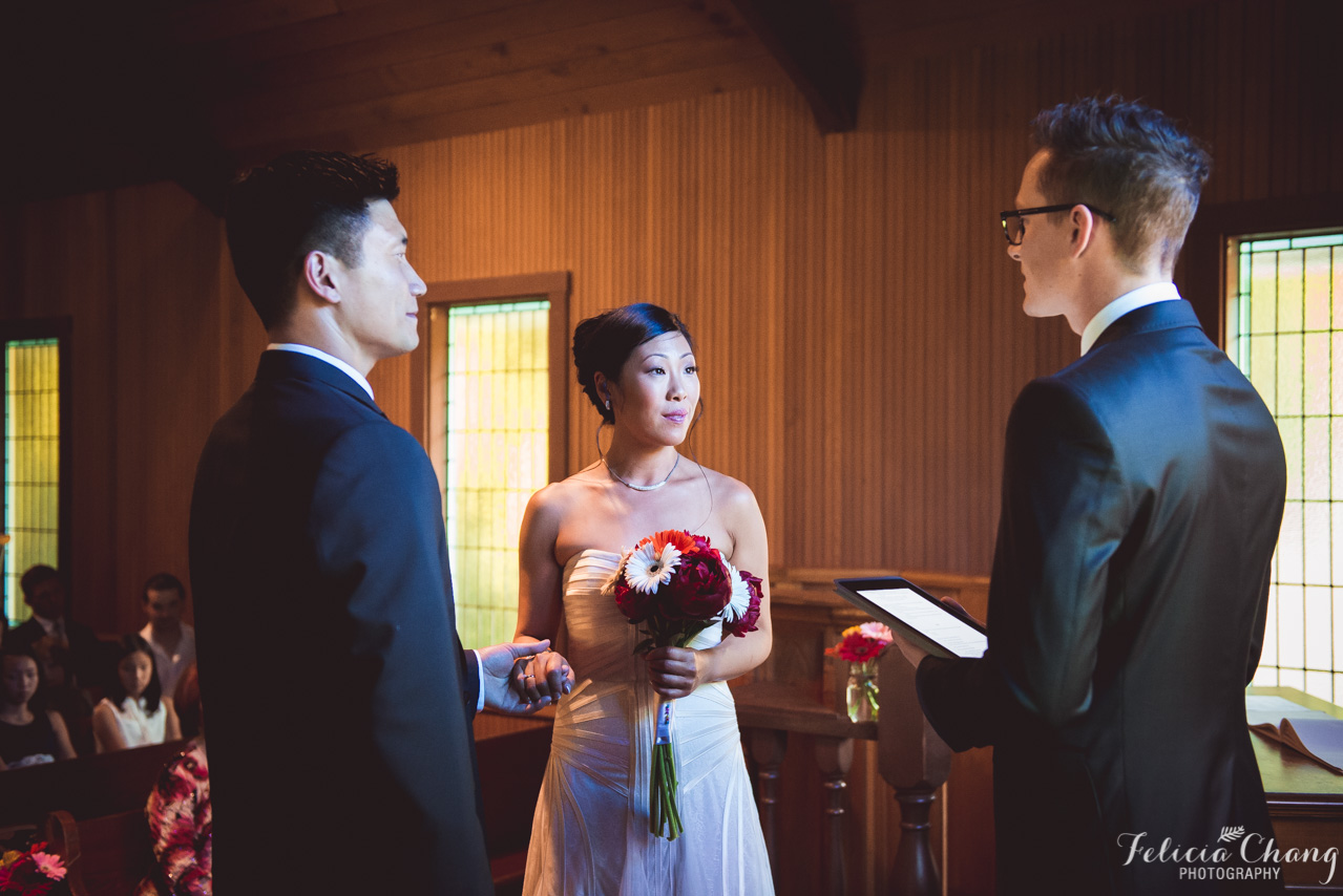 exchanging their vows at church wedding, pastor with iPad notes