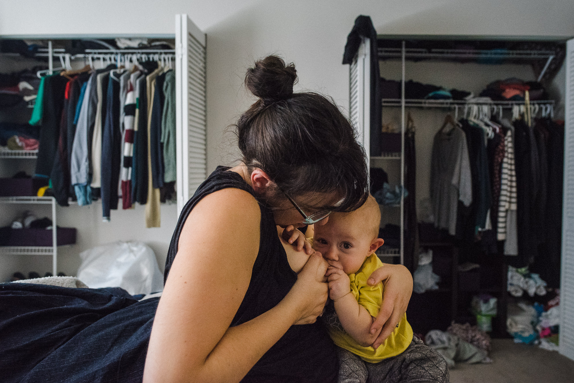 mom breastfeeding her baby in her bedroom