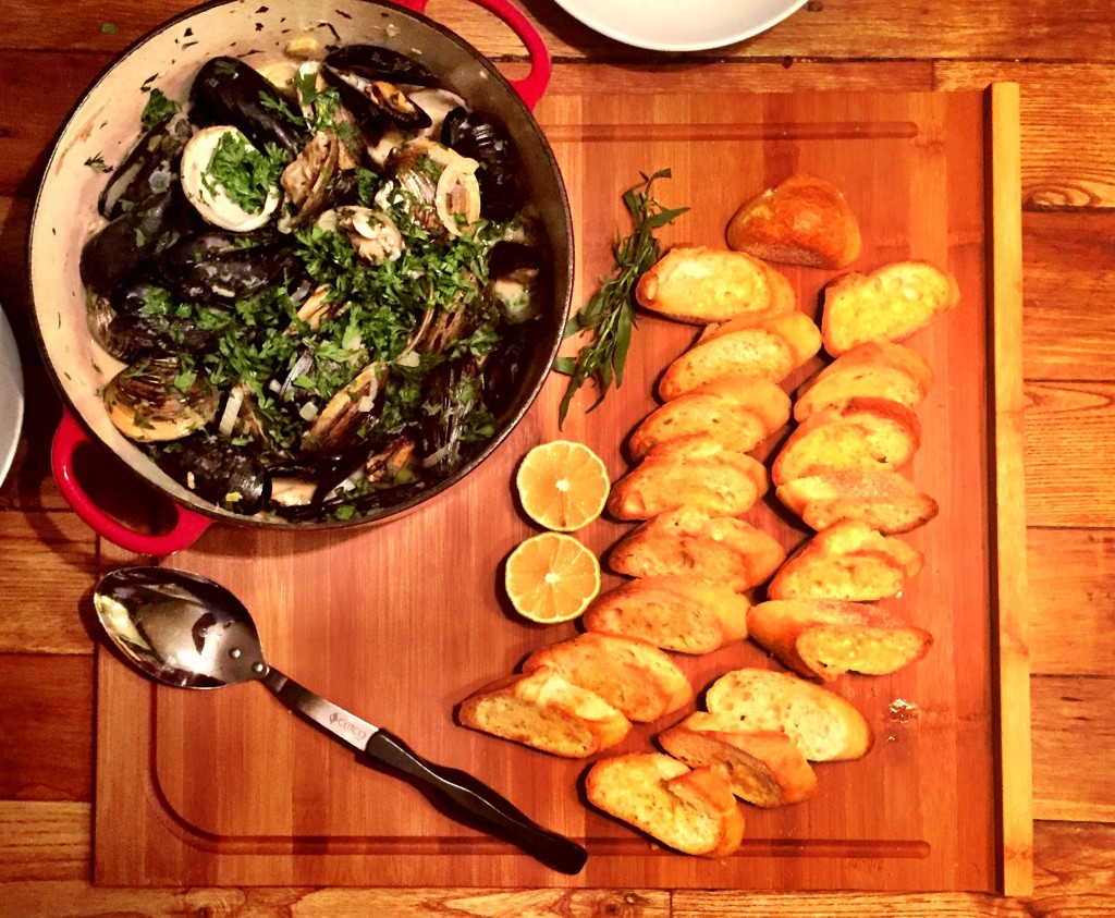 Presentation of mussels and clams served in white wine sauce