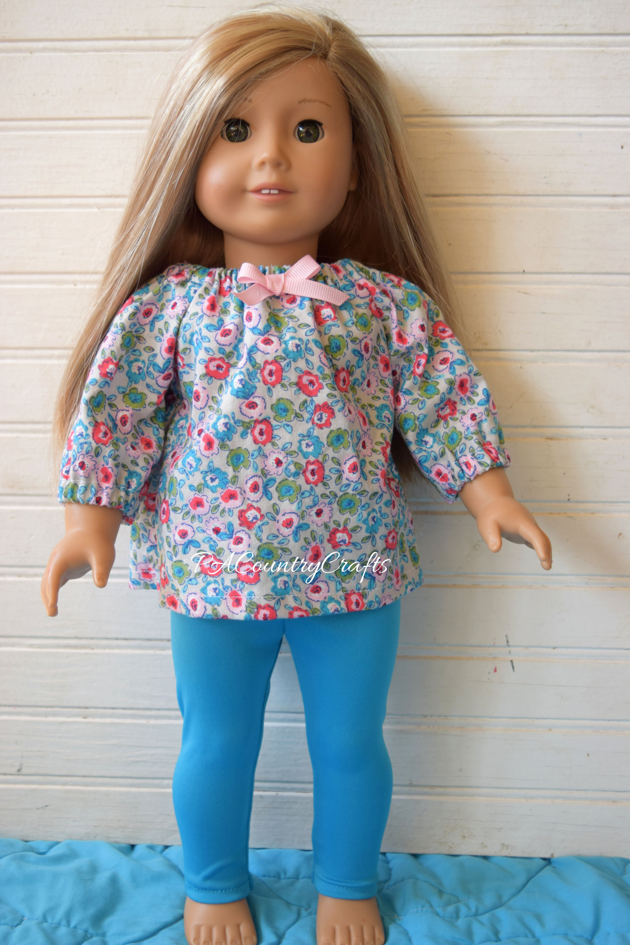 gray doll top and blue leggings