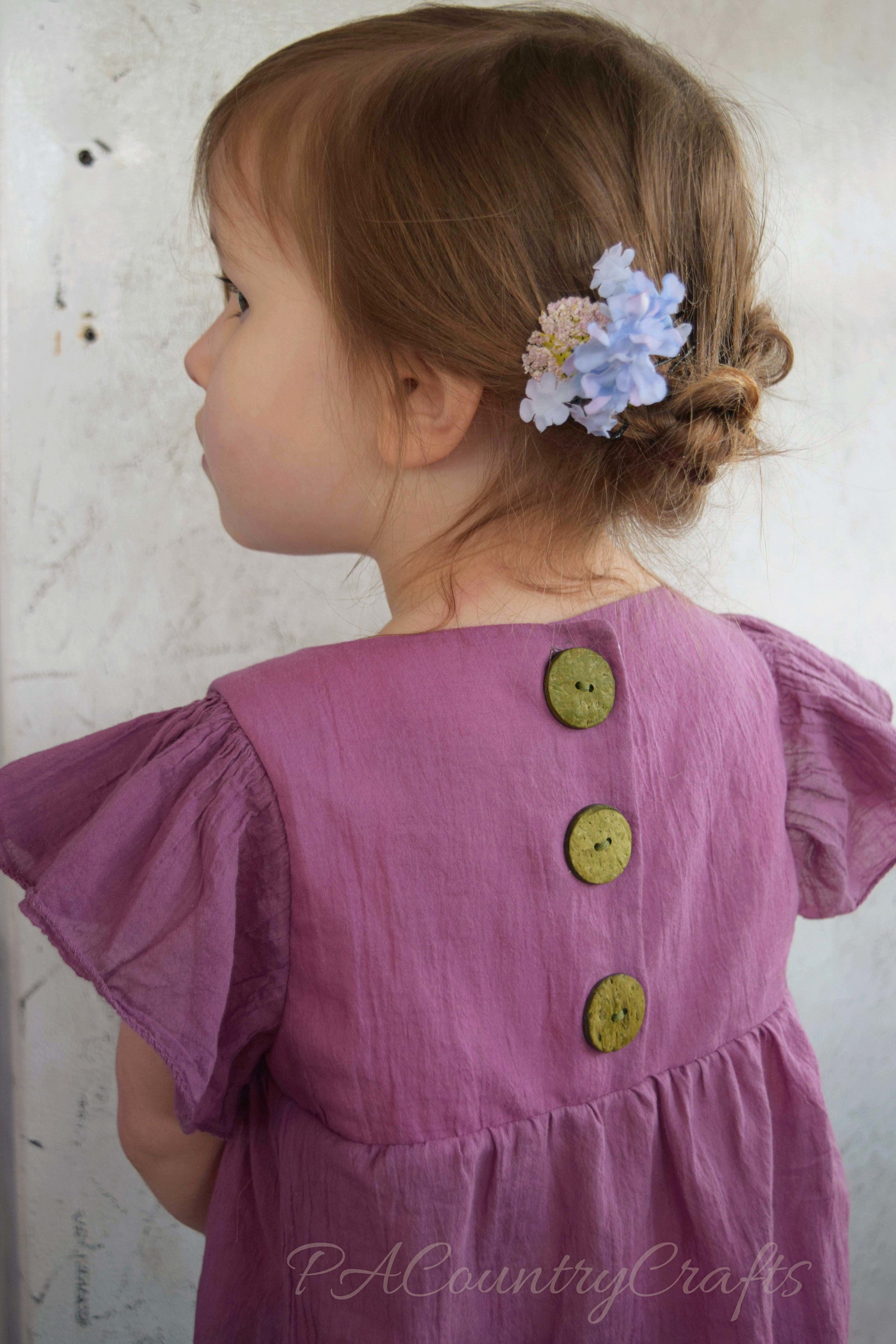 buttons on the back of a flowy, boho tunic