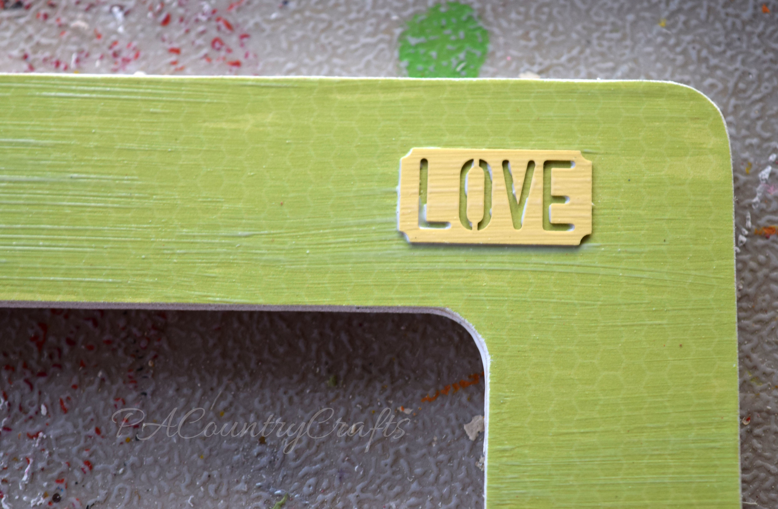 Cute embellishments on a DIY frame. Mod podge is great!