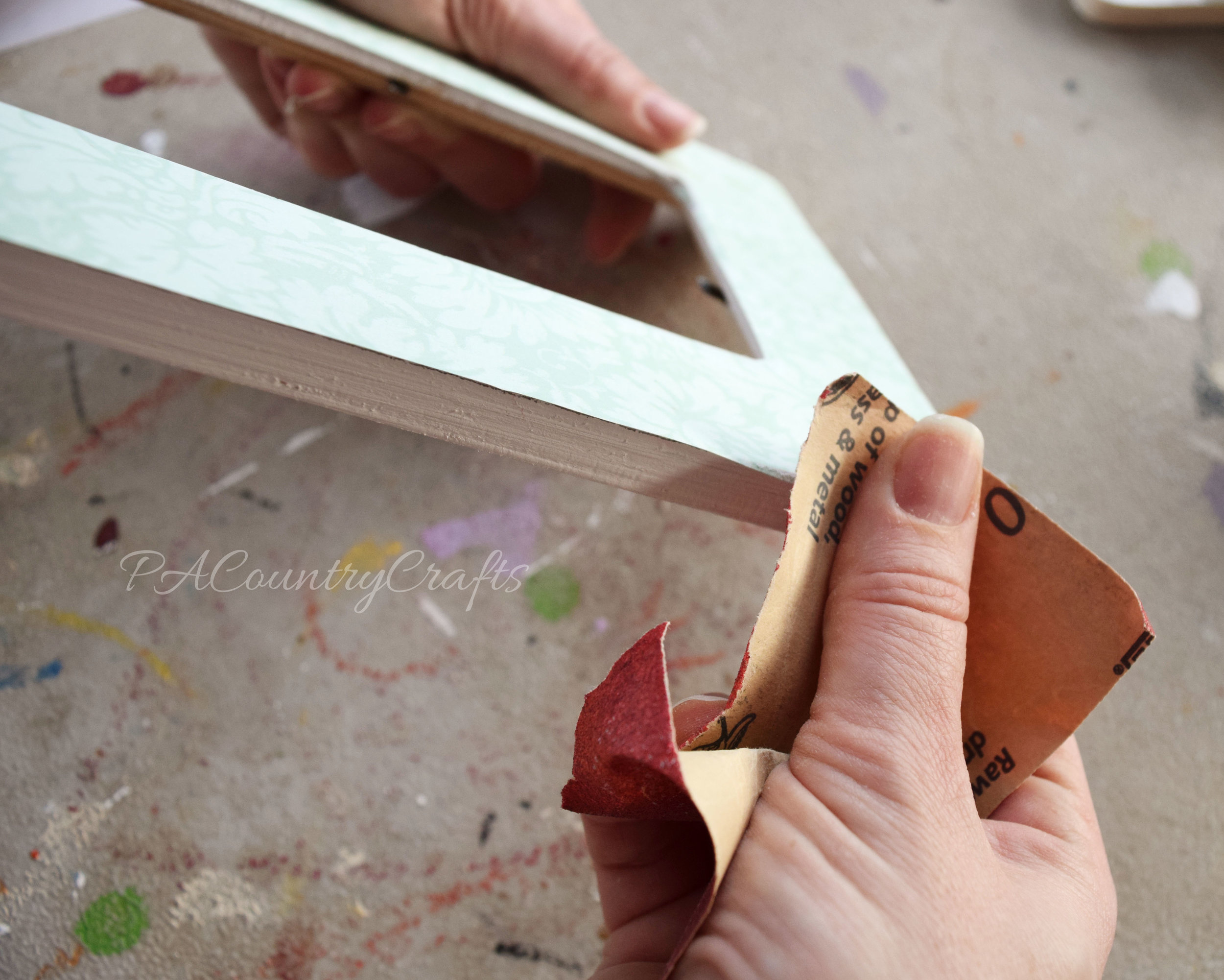 This tip helps you sand extra paper of the edges of mod podge frames for a clean finish.