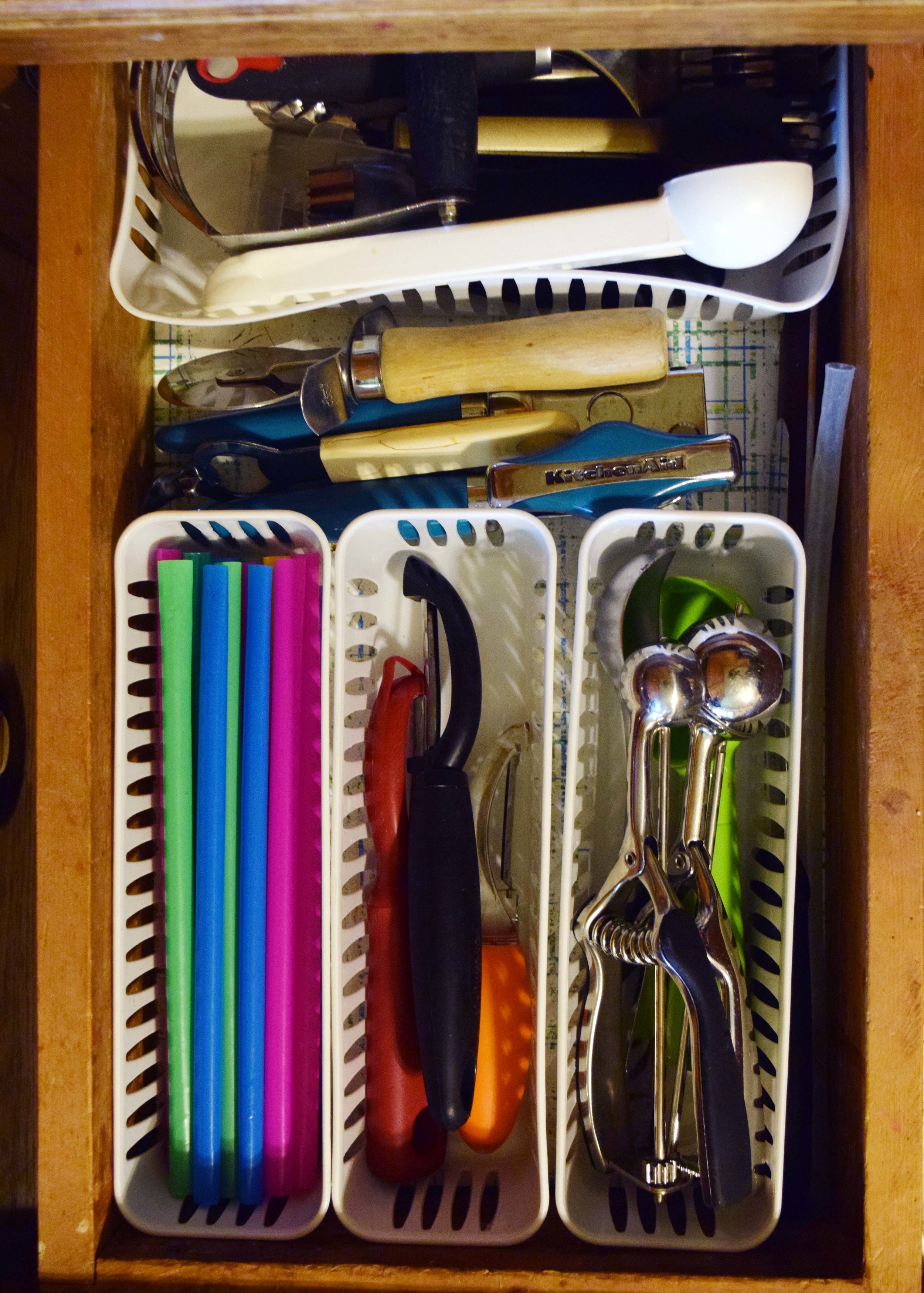 Neatly organize kitchen gadgets with dollar store bins.