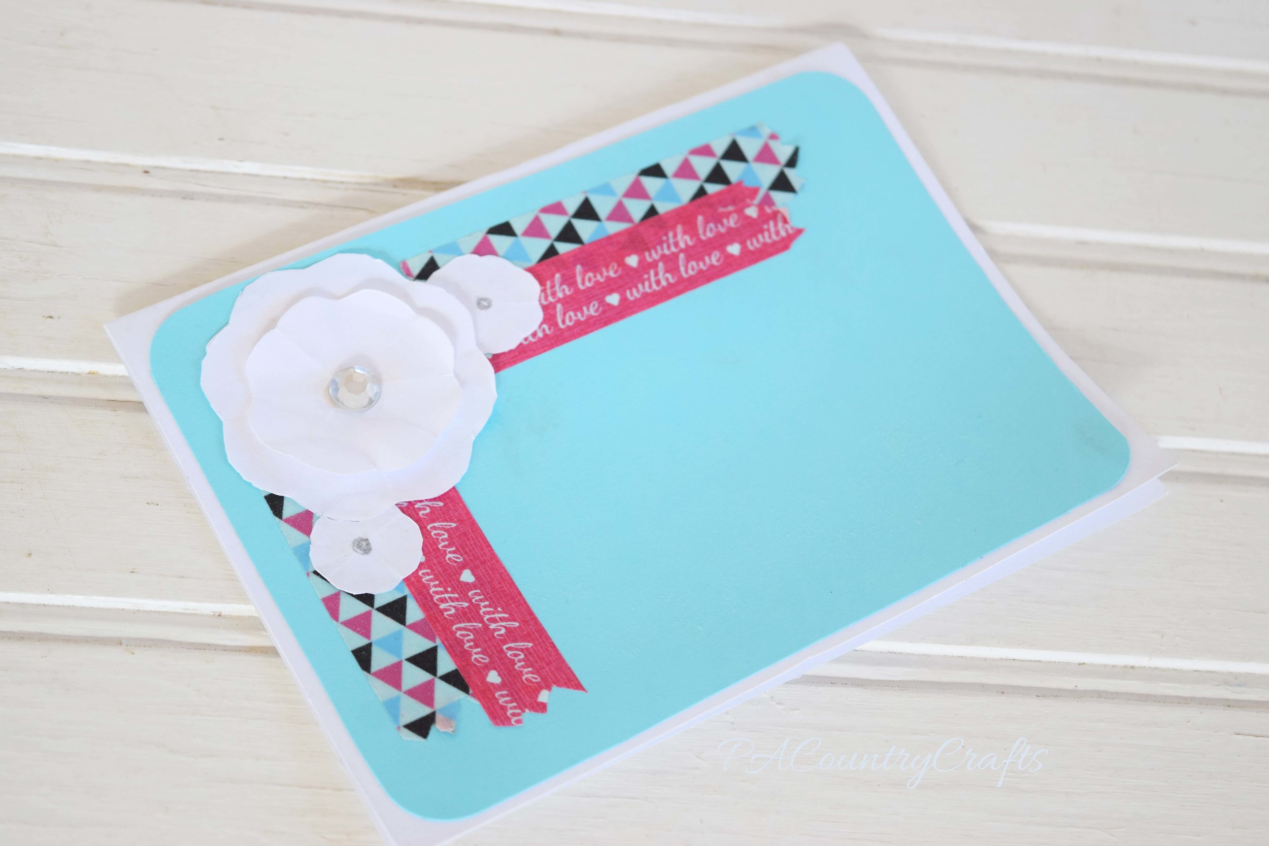 Cute flower embellishment on a blank card with washi tape!