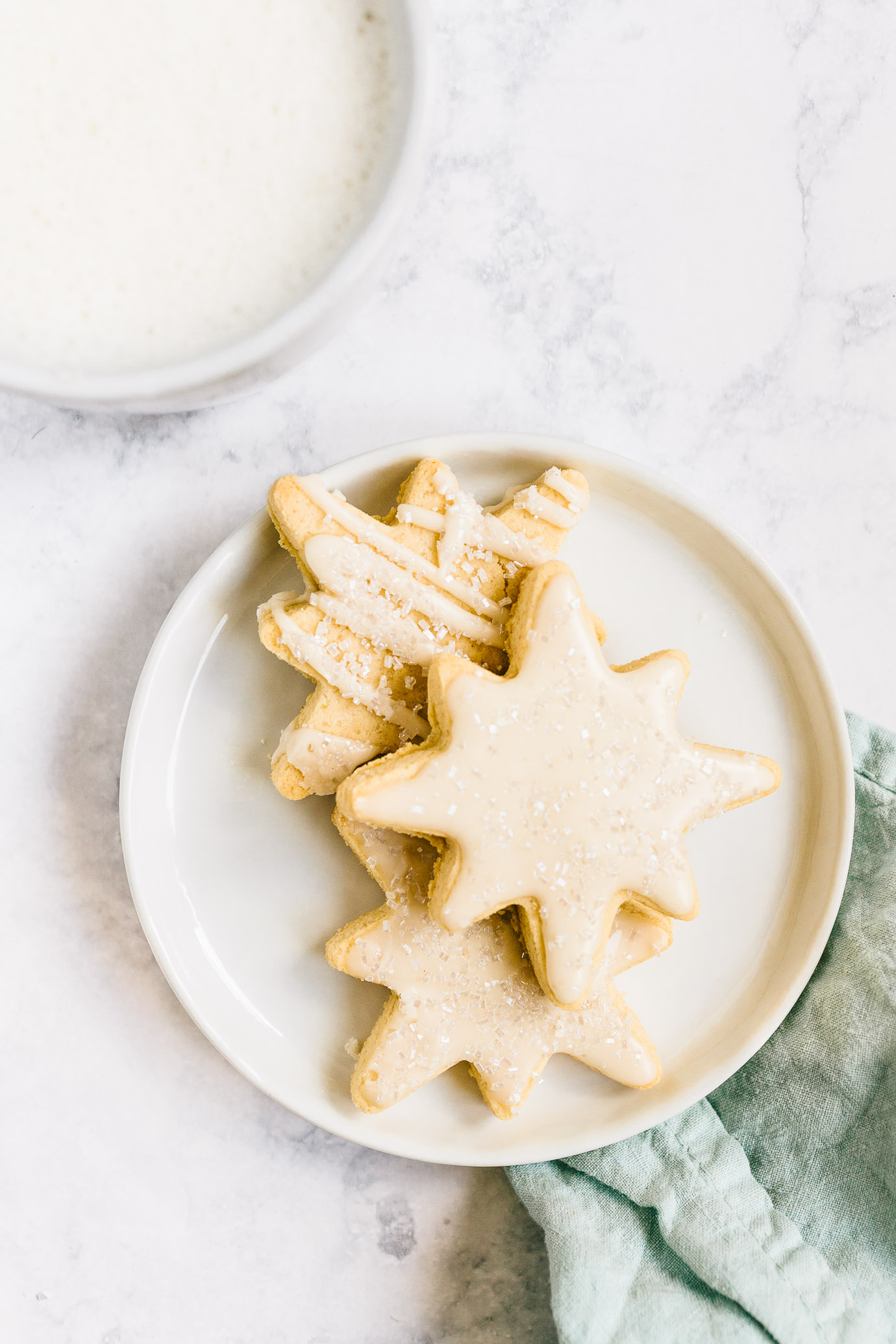 plate of iced Almond Flour Sugar Cookies cut-outs