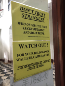 Posted signs warning against tourist traps. Image: Hannah Everett. 