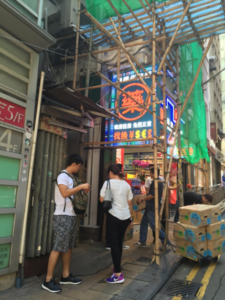 Once on D'Aguilar Street, turn down this alley underneath the neon Chinese sign to find Brickhouse! 