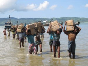 Source: Flickr Rohingya men carry vital aid supplies