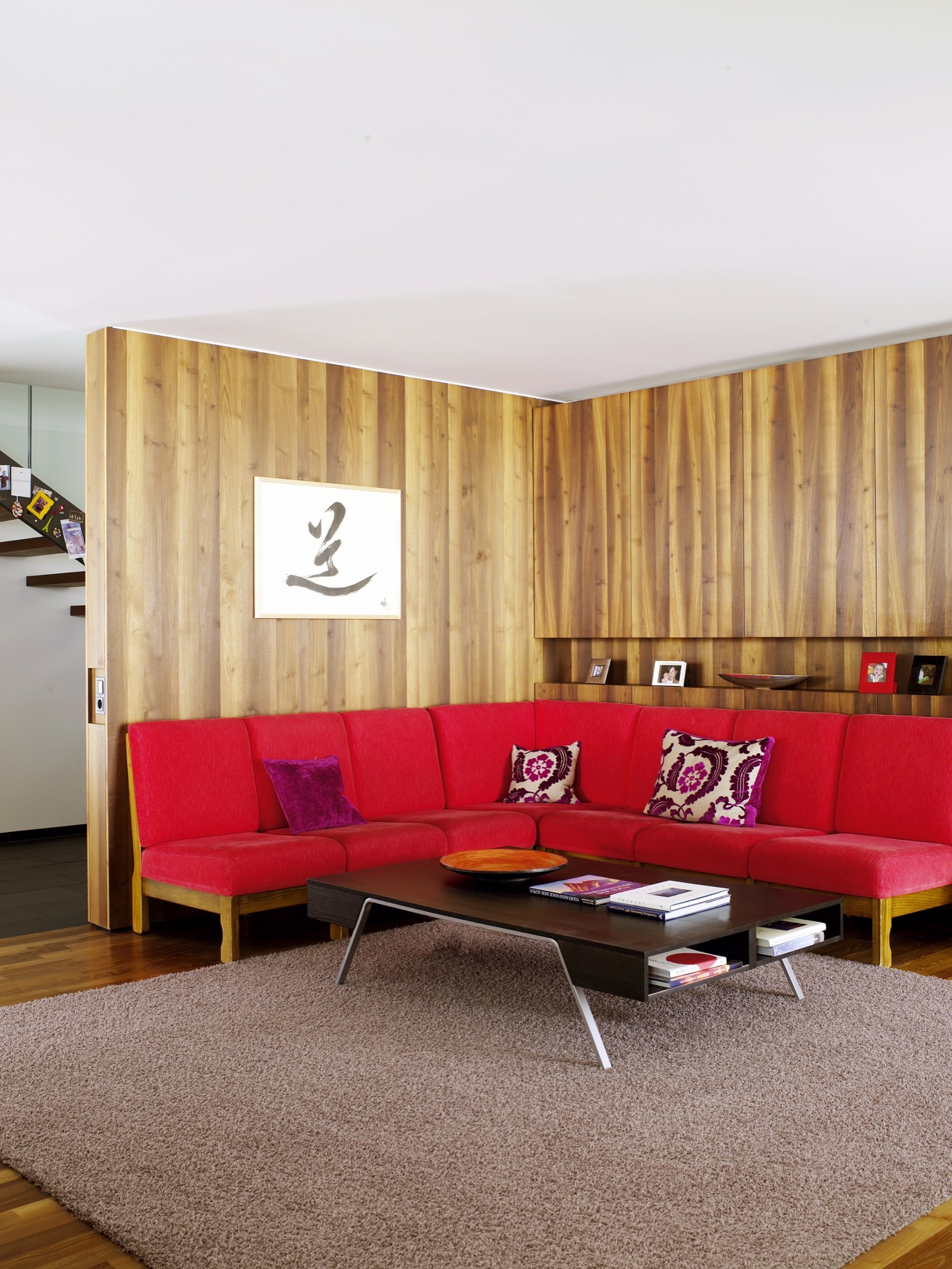 The red sofa in the living room is a 1960s piece originally owned by Strolz’s parents.