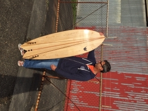 The wonderful finished product.  E and his hollow wooden surfboard.