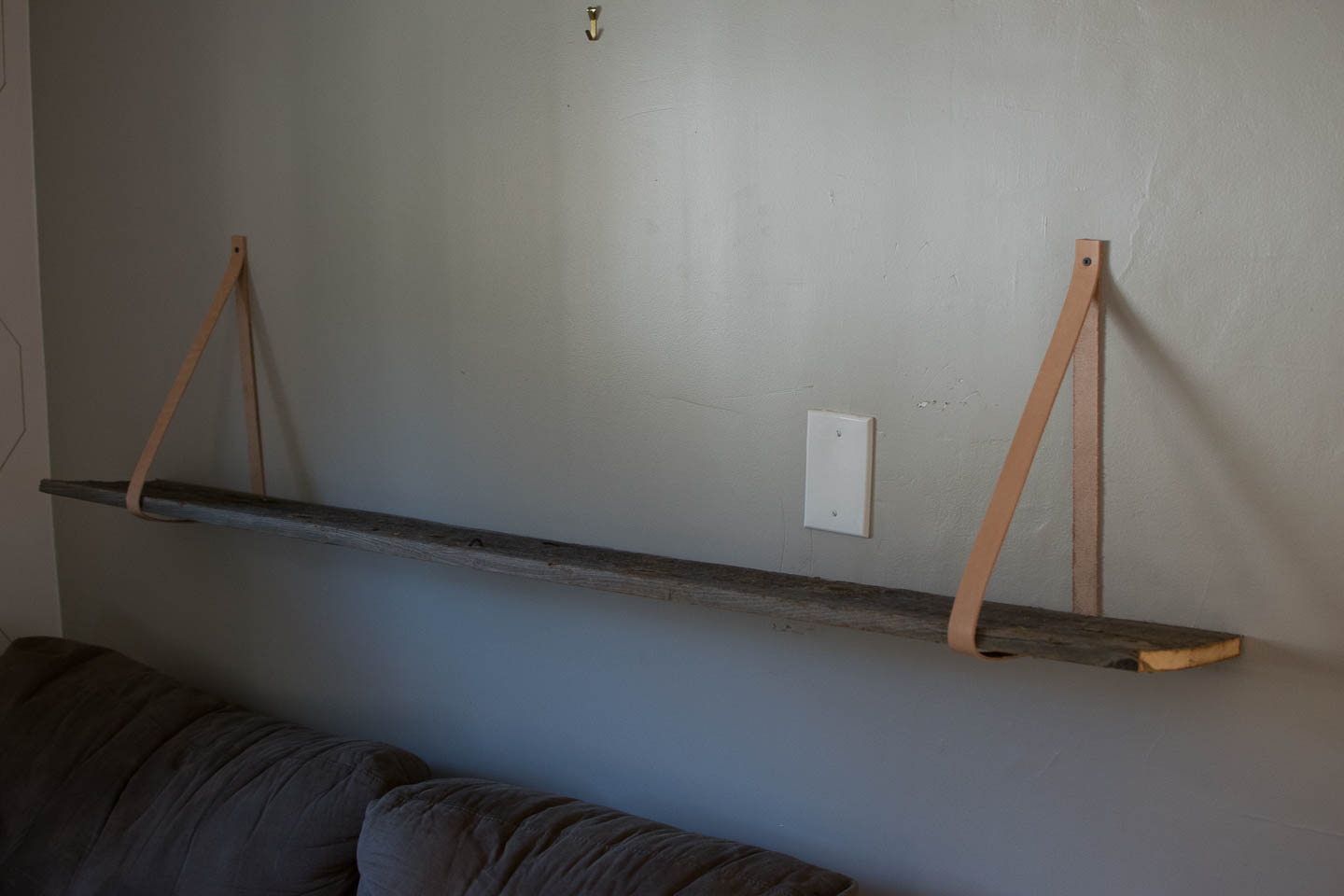 Simple DIY shelf with reclaimed wood and leather straps