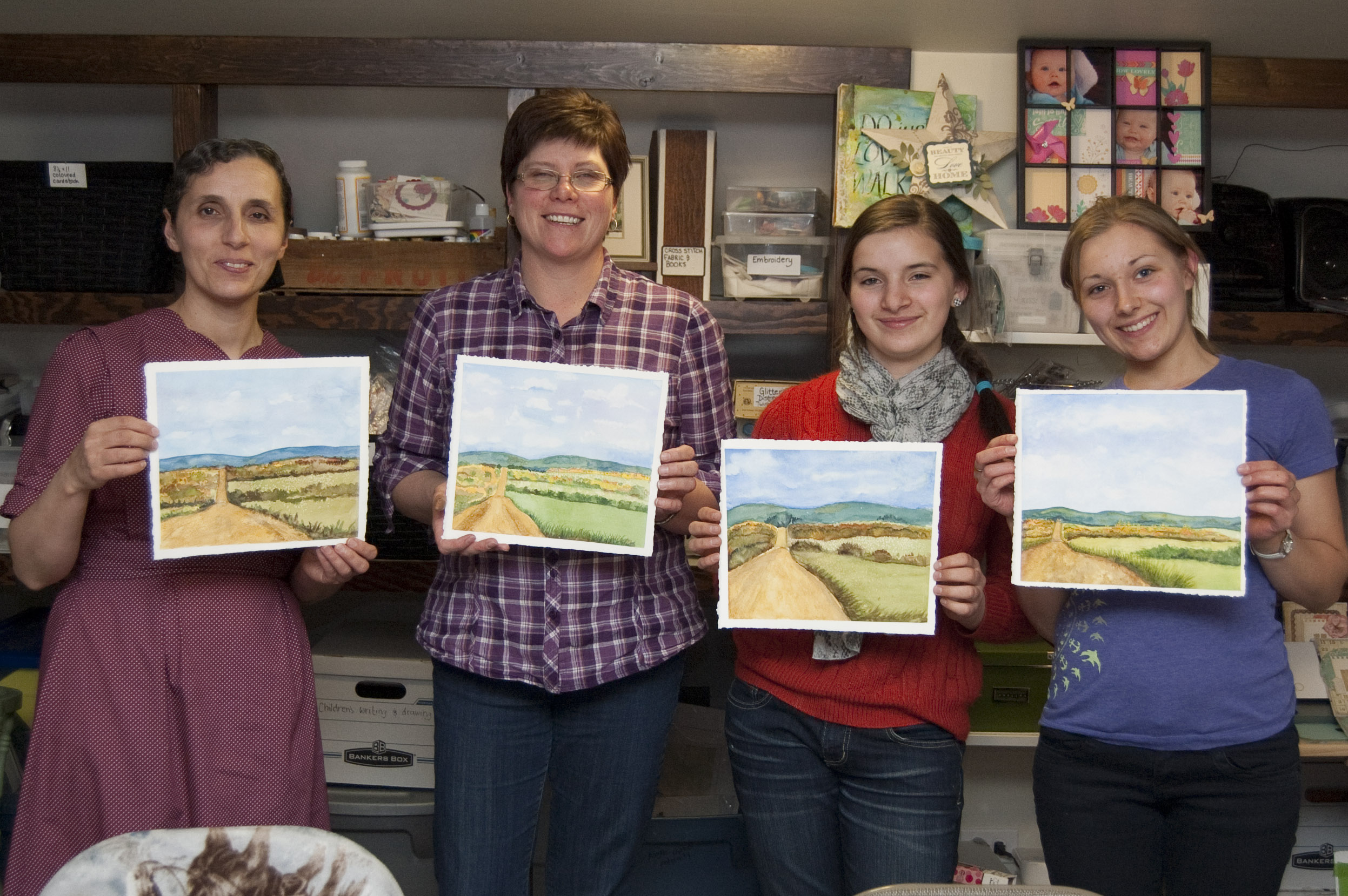My spring watercolour students with a completed landscape painting.