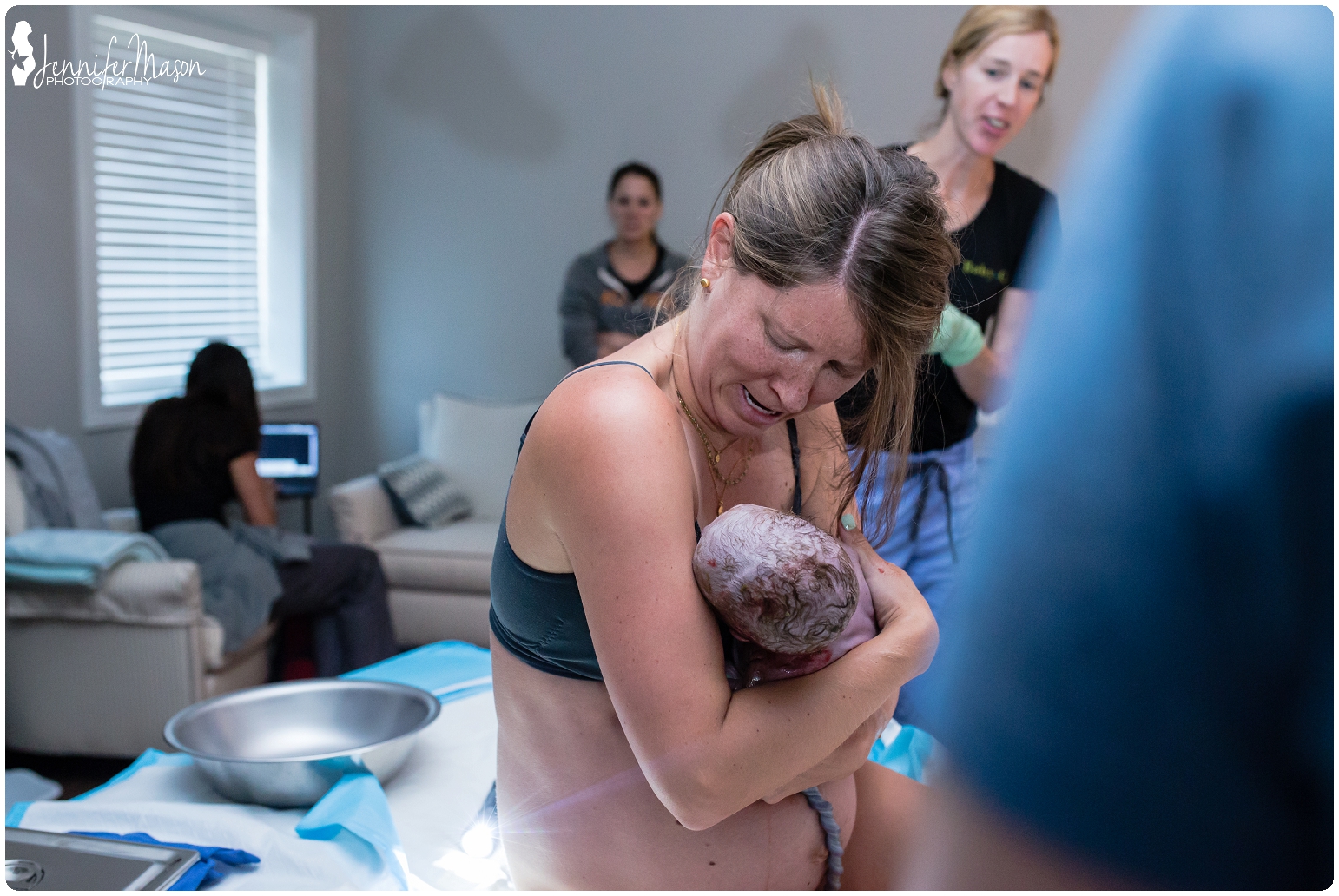 Mom catches her own baby during family centered birth at baby + co