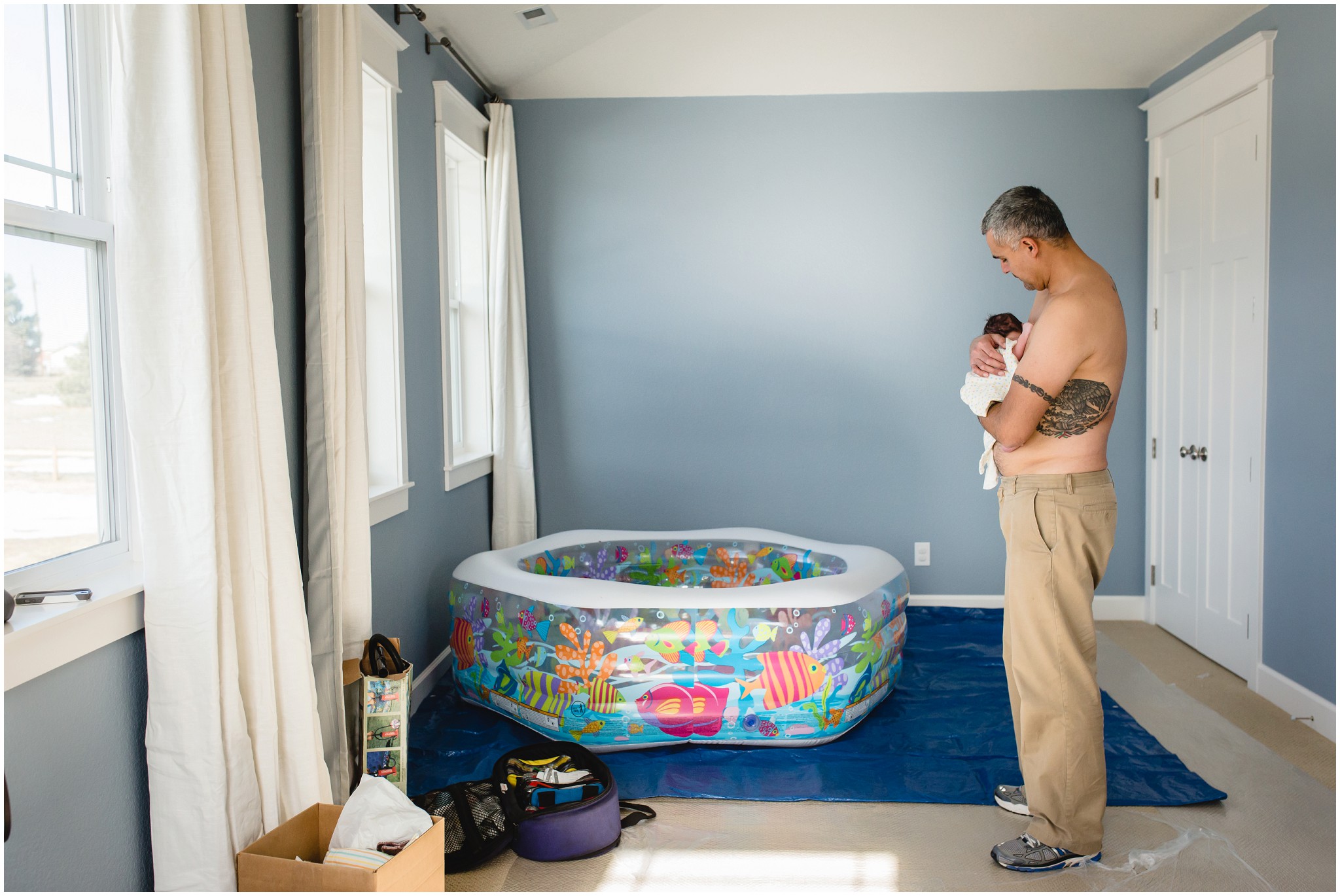 Home Birth Photographer in Parker captures dad holding baby