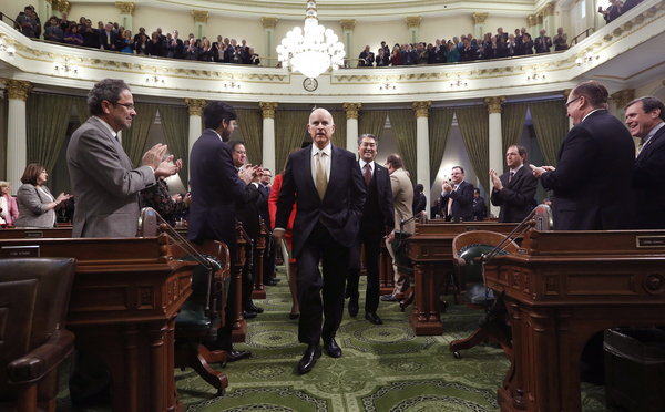Gov. Jerry Brown receives applause from lawmakers as he walks to podium of the Assembly chambers to deliver his State of the State address at the Capitol in Sacramento, Calif., Wednesday, Jan. 22, 2014. Brown delivered a dual message in his annual address to the Legislature, that a California resurgence is well underway but is threatened by economic and environmental uncertainties.(AP Photo/Rich Pedroncelli, pool)