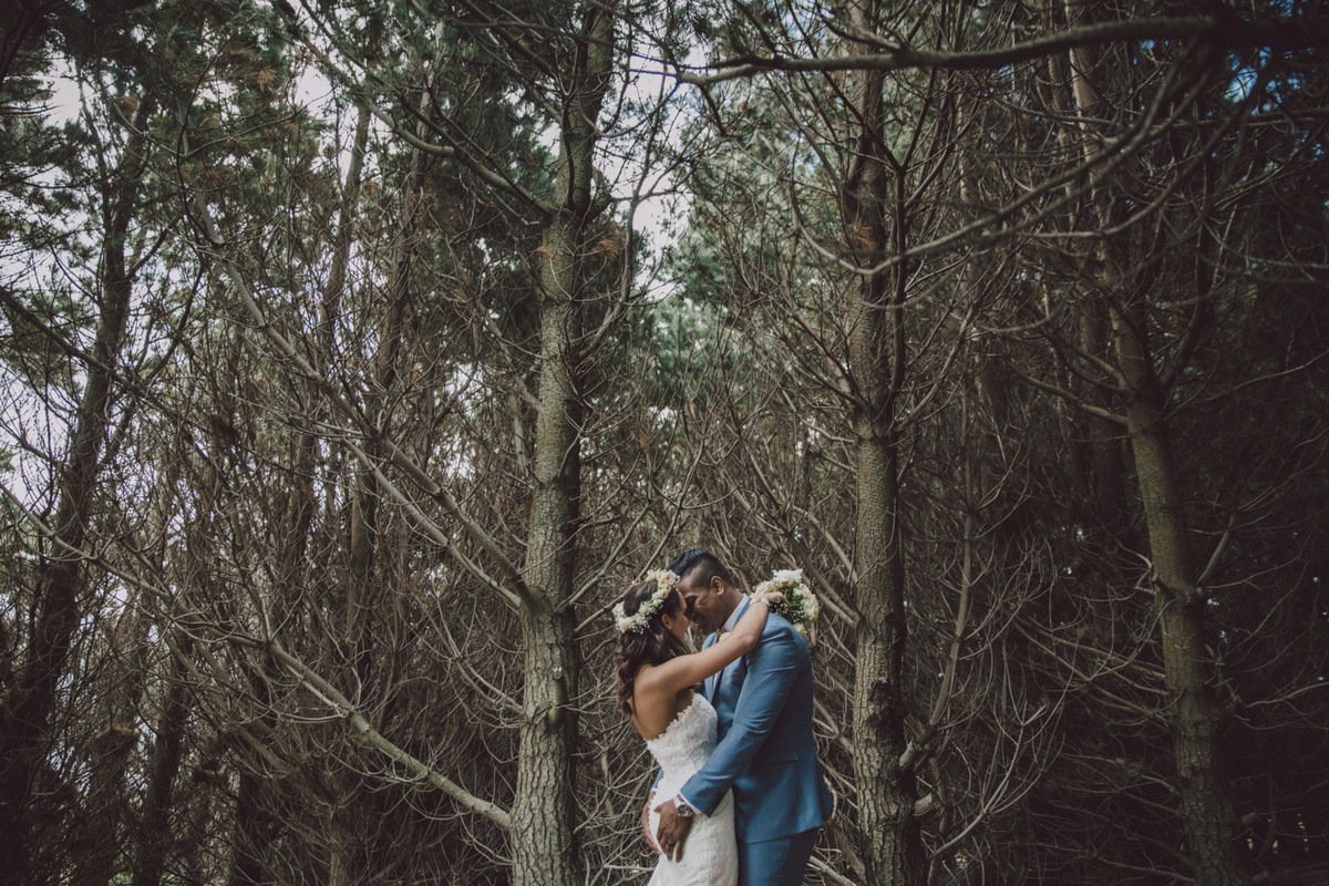 Fatima and Julian Savea, Bride and Groom cuddles in the woods. Photo by Sarah McEvoy