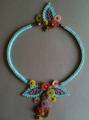 Blue herringbone necklace with pendant made of brick-stitched flowers and Russian leaf elements.