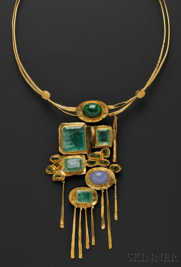 Ancient-looking geometric multi-stone pendant on a round gold necklace base.