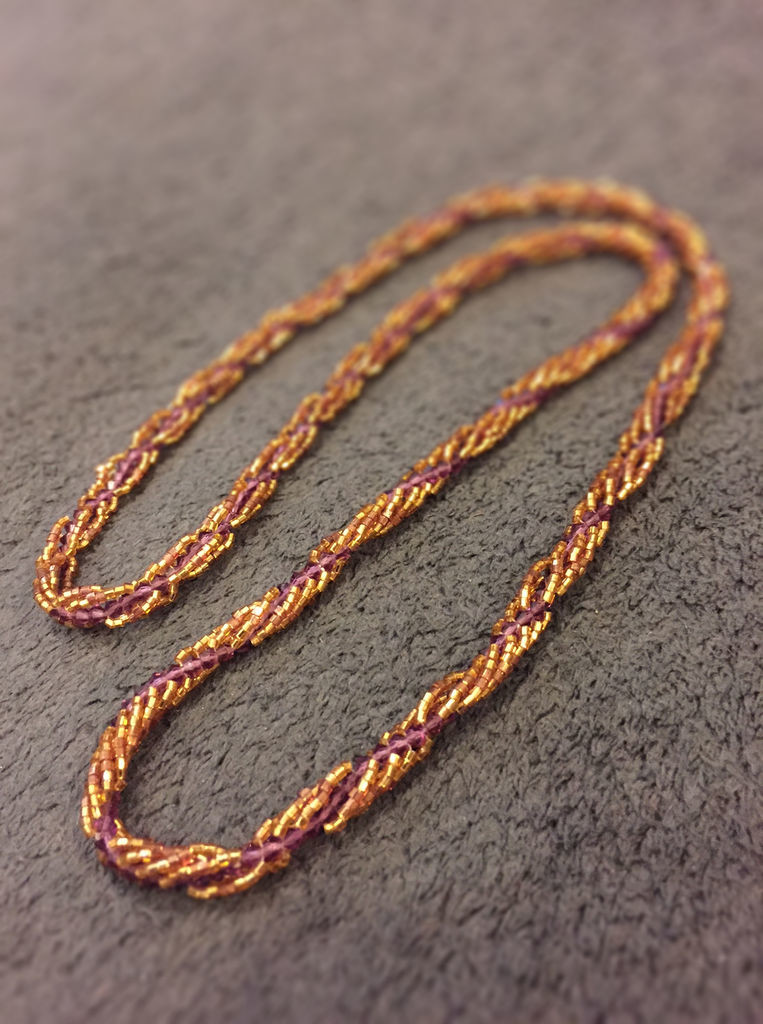 A purple and gold spiral stitch rope.